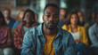 © ifoto - Black man sitting in group therapy, serious expression with other people around him,