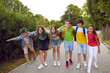 © Studio Romantic - Happy school friends children boys and girls in casual clothes with backpacks standing in summer park smiling and hugging each other walking during holidays or after study day with classmates