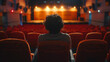© Sawyer0 - Empty, quiet cinema hall. The viewer, sitting alone in one of the armchairs, concentrates on the film displayed on the screen.