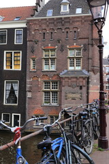 Wall Mural - Amsterdam Vredenburgh Building Facade View from the Armbrug Bridge with Parked Bicycles, Netherlands