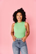 © LIGHTFIELD STUDIOS - A stylish woman in a green top and jeans posing confidently.