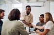 © MollerFinest/peopleimages.com - Creative people, handshake and meeting success, collaboration or welcome to internship induction or orientation. Startup agency and manager shaking hands with new employee for celebration or teamwork