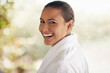 © peopleimages.com - Portrait, laughing and woman in hotel, holiday and relax in vacation, robe and hospitality in resort in USA. Happy, girl and bokeh in break, morning and pride for luxury, travel and getaway of person