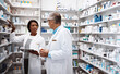 © ReeseArcurs/peopleimages.com - Medical, people and conversation with tablet in pharmacy for inventory, update and prescription. Healthcare, intern and pharmaceutical student with mentor by pills for dispensary, training or support