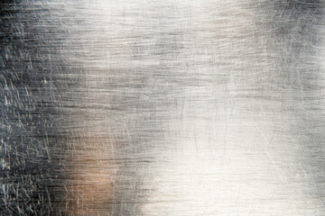 Wall Mural - close-up of a textured metal surface with visible scratches and a shiny finish, creating an industri