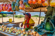 © poco_bw - african woman vegetable street vendor, self employed working at her street stall selling fresh produce