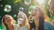 © AlfaSmart - Group of friends outdoors, laughing and playing with soap bubbles