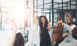© peopleimages.com - Presentation, Hands raised and business people with question in office for finance meeting. Discussion, team and speaker with audience of financial advisors with answer or vote at corporate seminar.