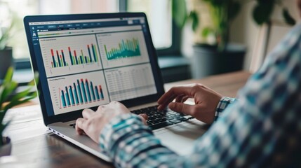 Leinwandbilder - A person working on a laptop with multiple graph windows open, showcasing data analysis.