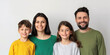 © PrettyStock - Happy Family Portrait with Smiling Parents and Children on White Background