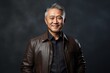 © Markus Schröder - Portrait of a grinning asian man in his 50s sporting a stylish leather blazer isolated on bare monochromatic room