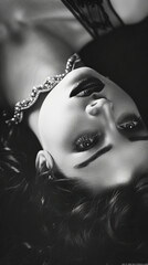 Wall Mural - Black and white photo of a woman laying on her back in a pose