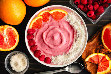 Wall Mural - Raspberry Orange Smoothie Bowl Garnished with Coconut: Pink smoothy bowl garnished with raspberries, orange slices, and shredded coconut