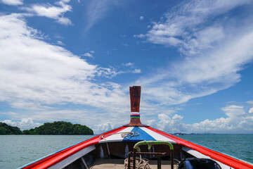 Longtail Boat in Andaman sea, Krabi Thailand. Sailing ship and traditional boat. View from a traditional Thai wooden prow boat while floating in the bay provides a tourist with beautiful scenery.