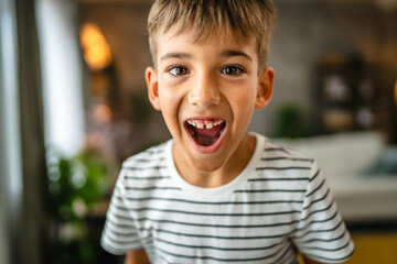 Portrait of young boy stand and smile laugh in the living room