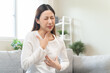 © Pormezz - Acid reflux disease, suffer asian young woman have symptom gastroesophageal, esophageal, stomach ache and heartburn pain hand on chest from digestion problem after eat food, Healthcare medical concept