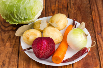 Wall Mural - Different fresh peeled vegetables and dried spices on rustic table