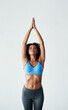 © peopleimages.com - Fitness, woman and stretching arms for yoga in studio with exercise, balance and body flexibility of zen wellness. Smile, female person and training, warm up and spiritual health on white background