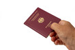 © Jakob - A hand holds a German citizen's passport on a white background. European passport close-up.