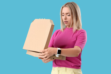 Sticker - Thoughtful young beautiful woman with cardboard pizza box on blue background