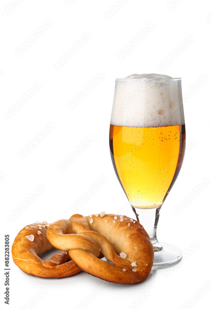 Soft pretzel and glass of beer on white background