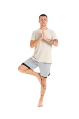 Sticker - Young man doing yoga on white background