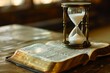 © Kaleb - An hourglass on top of a Bible on a wooden table