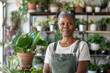 © Jasmina - Portrait of a happy and smiling black woman, small business owner in her plant retail store