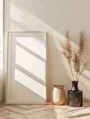 Canvas Print - This image depicts a minimalist interior design with a framed canvas, vases, and pampas grass bathed in soft natural light.