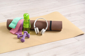 Sports equipment with headphones on floor in room