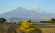 © Laura - Pico de Orizaba volcano and Sierra Negra with forests, fields and blue sky in Mexico, ecotourism in Mexico, beautiful natural landscape of Mexico