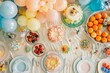 © Elmira - A top-down view of a beautifully decorated table for a children's birthday party. Colorful balloons, cakes, and party favors fill the table, creating a festive atmosphere