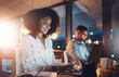 © peopleimages.com - Laptop, night and business woman in office with research for wealth management report with deadline. Computer, typing and African female actuary working overtime on financial investment analysis.