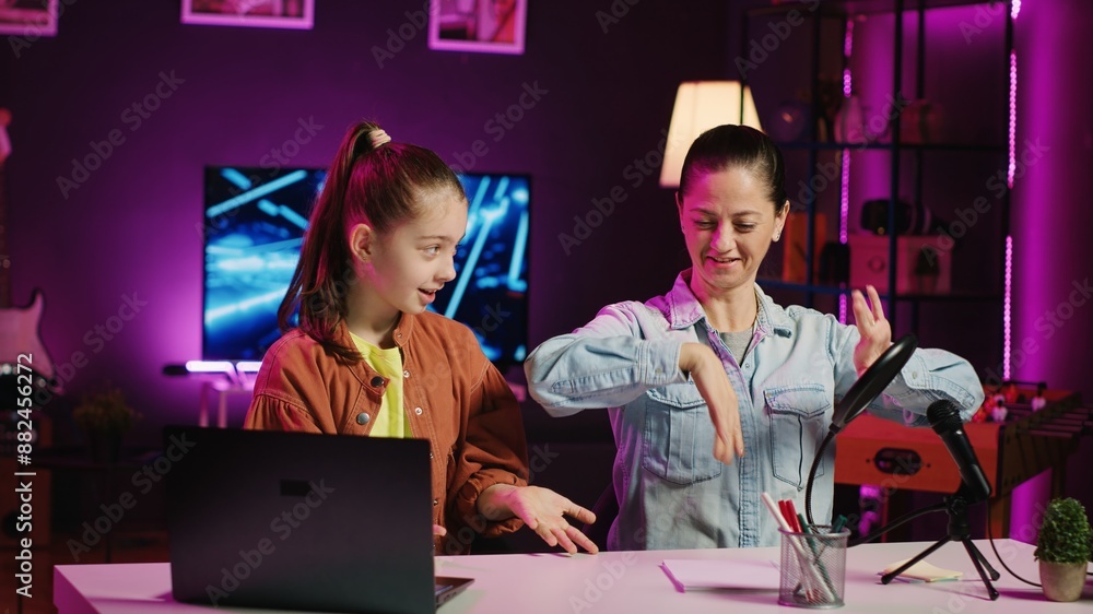 Young girl teaching her mother how to do viral online dance moves while ...