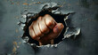 © Prasanth - A fist is shown through a hole in a wall. The fist is clenched and the hand is visible. Concept of strength and power