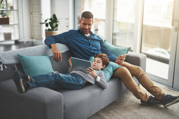 Poster - Man, relax and kid with tablet on sofa for online entertainment, network and bonding together. Family, home and son with tech by father for internet, connection and download of game in living room