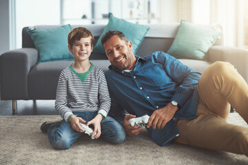 Canvas Print - Happy father, portrait and video games with child for entertainment or bonding on floor at home. Excited dad, son or kid with smile or enjoying esport, competition or fun on console together at house