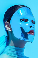 Wall Mural - A woman wearing a blue mask with a silver face