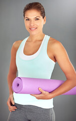 Poster - Woman, portrait and yoga mat on gray background for exercise, wellness and health as morning routine. Female person, face and pilates with smile or happiness for challenge, progress and self care