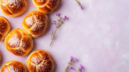 Wall Mural - Freshly Baked Bread Rolls with Flowers on Pink Background.