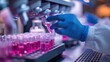 © G.Go - A scientist is working with a pink liquid in a lab