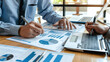 © Chatchanan - Consultants conducting a financial projection analysis, discussing future revenue streams and potential investments.