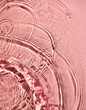 © Uuganbayar - Closeup of pink transparent clear calm water surface texture with splashes and bubbles. Trendy abstract summer nature background. Coral colored waves in sunlight.