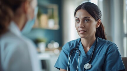 Canvas Print - A woman in a blue scrubs is talking to a woman in a white coat