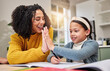 © peopleimages.com - Mom, smile and high five with girl for homework, correct answer and learning math in home. Mama, daughter and excited with palm connection for education, celebration and success for teaching equation