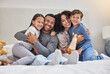 © peopleimages.com - Family, portrait and hug in home bedroom with smile for wellness, relationship and trust in morning. Parents, face and children on bed for happy, bonding and relax together with support on weekend