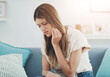 © peopleimages.com - Home, sofa and woman with toothache or mouth in pain for dental problem and discomfort of cavity. Frustrated, sore and person with sensitive tooth for wisdom teeth, inflammation and oral infection