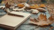 © AIArtistry - Diary and pen on wooden table with fall leaves