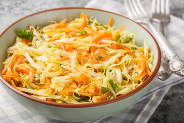 Canvas Print - Lahanosalata Greek Cabbage Salad Vinegar Coleslaw with carrot and parsley seasoned with olive oil closeup on the bowl on the table. Horizontal