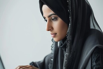 Wall Mural - Young Woman in Hijab Concentrating on Work